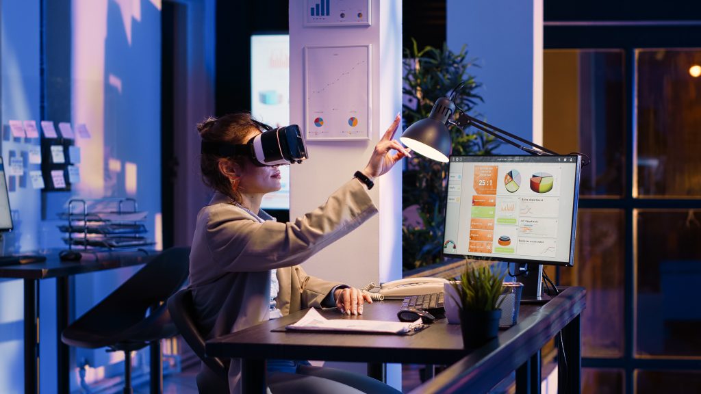 Fig 2 - A women using a comuter system and wearing a AR headset.